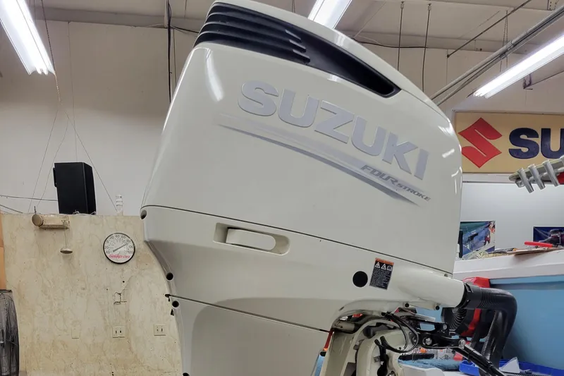 Slide: The Image of 1988 Hydra-Sports 2500 CC with Suzuki outboard motor in a workshop. - 13