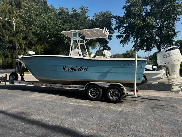 Slide: The Image of 1988 Hydra-Sports 2500 CC boat on trailer with Headed West name. - 3