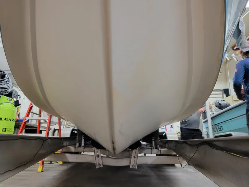 Slide: The Image of 1988 Hydra-Sports 2500 CC boat hull on trailer in a workshop. - 6