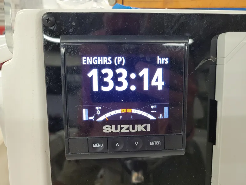 Slide: The Image of Suzuki engine hour meter displaying 133:14 hours on a 1988 Hydra-Sports 2500 CC boat. - 7