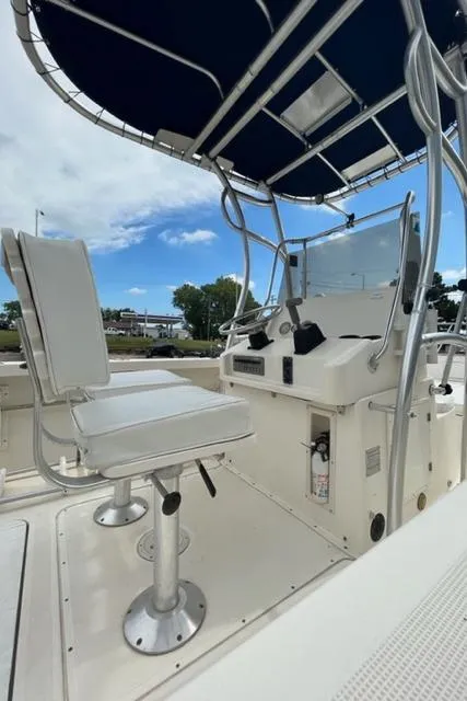 Slide: The Image of 1995 Pursuit 2150 Center Console boat with white seating and blue canopy. - 6