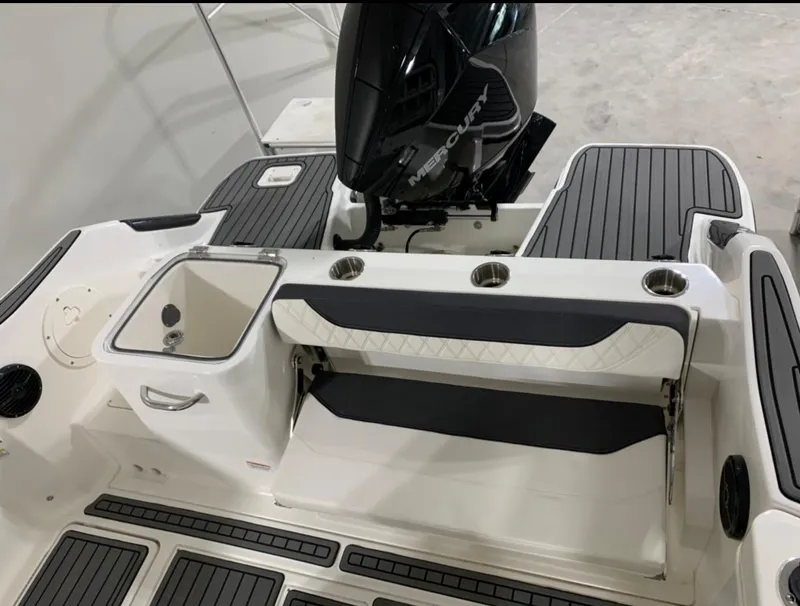 Slide: The Image of 2024 Bayliner Trophy 24 CC boat interior with seating and outboard motor. - 11