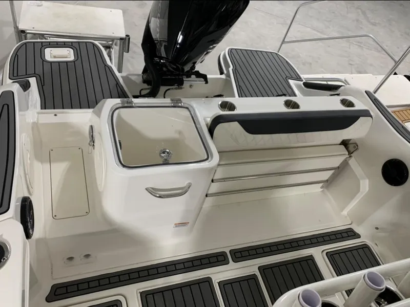 Slide: The Image of 2024 Bayliner Trophy 24 CC boat interior with seating and storage compartments. - 12