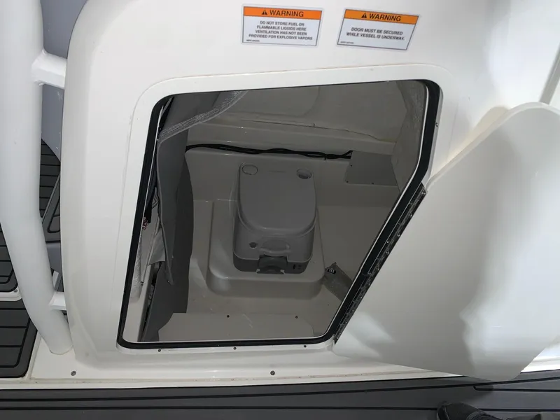 Slide: The Image of 2024 Bayliner Trophy 24 CC boat interior with built-in toilet. - 5