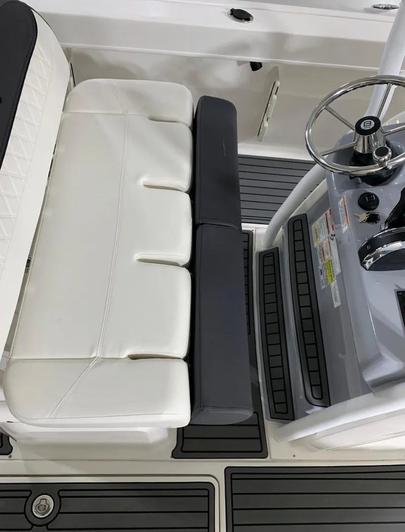 Slide: The Image of 2024 Bayliner Trophy 24 CC boat cockpit with seating and steering wheel. - 10