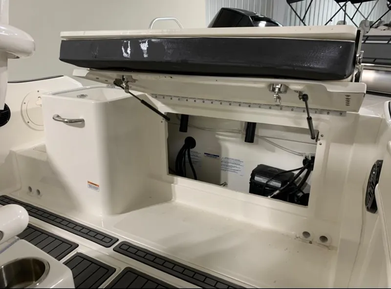 Slide: The Image of 2024 Bayliner Trophy 24 CC boat interior with open storage compartment. - 12