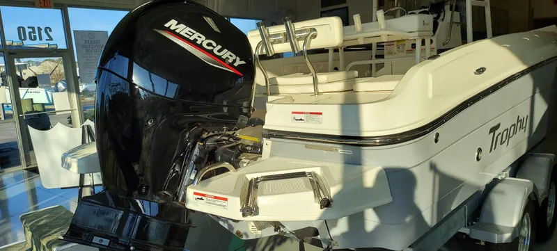 Slide: The Image of 2023 Bayliner Trophy T21Bay boat with Mercury outboard motor in showroom. - 2