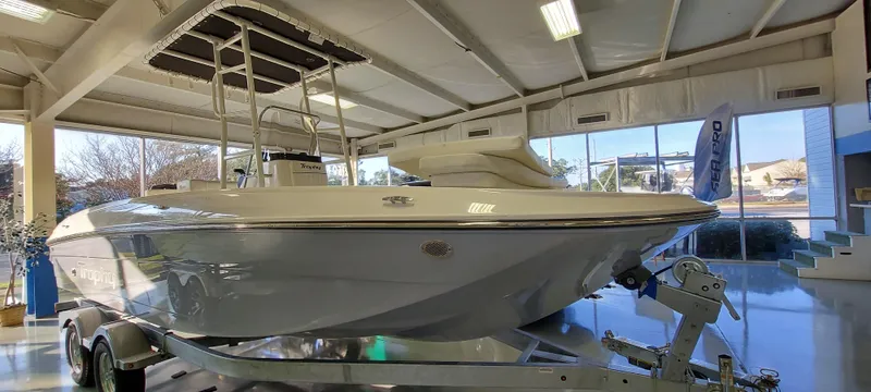 Slide: The Image of 2023 Bayliner Trophy T21Bay boat displayed indoors on a trailer. - 3