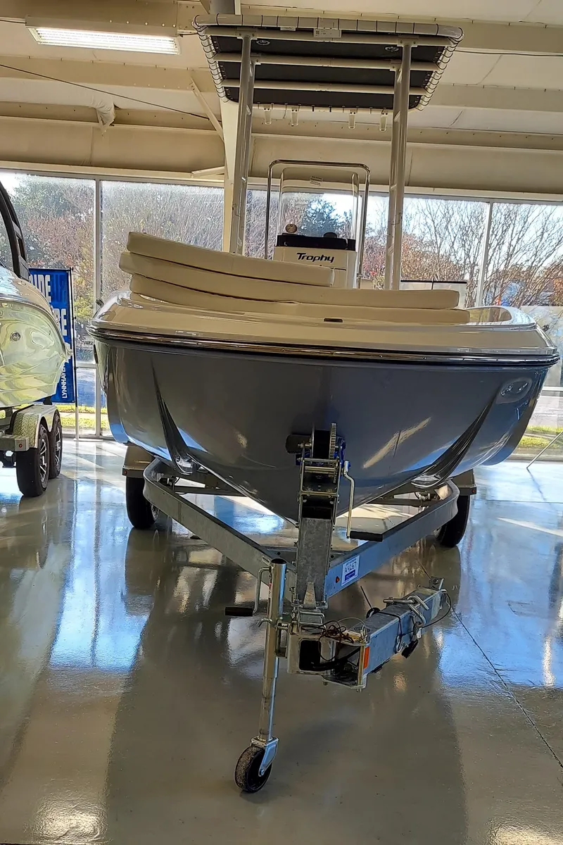 Slide: The Image of 2023 Bayliner Trophy T21Bay boat on display in a showroom. - 6