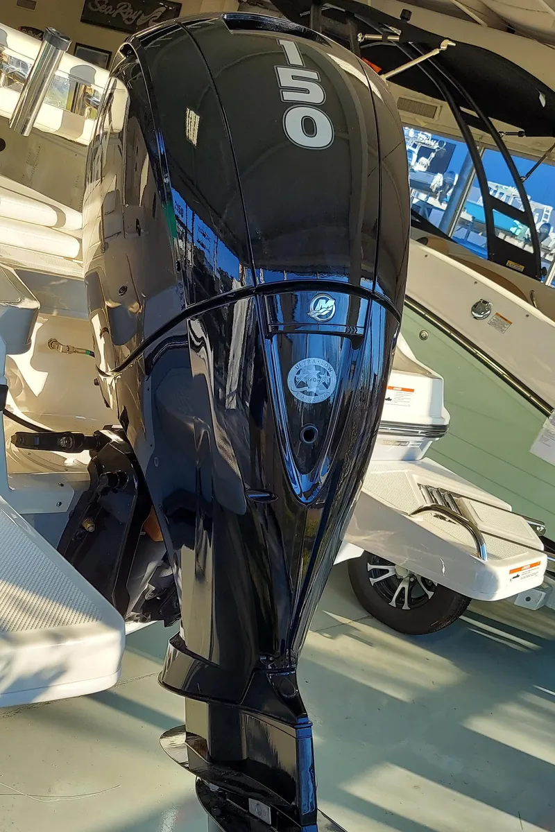 Slide: The Image of 2023 Bayliner Trophy T21Bay with a 150 HP outboard motor in a showroom. - 7