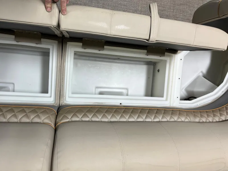 Slide: The Image of 2023 Ranger Reata 223C boat storage compartments under beige seats. - 12
