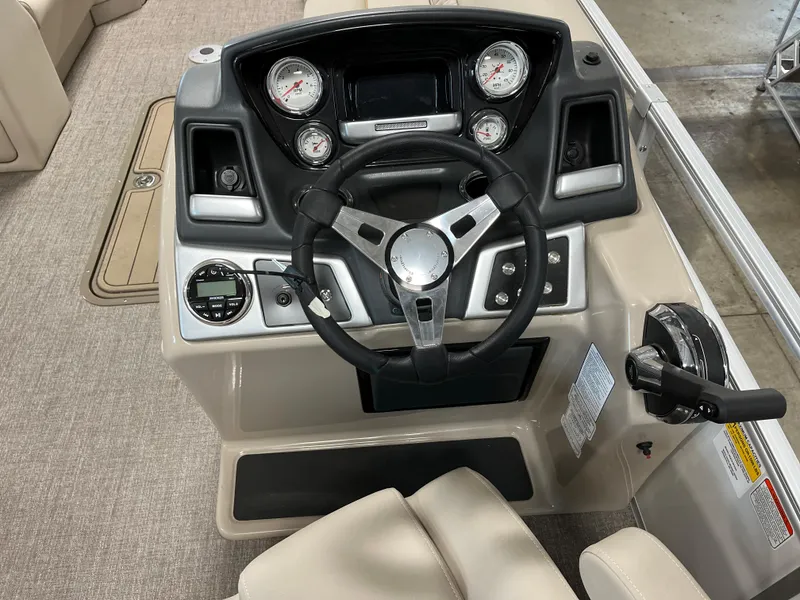 Slide: The Image of 2023 Ranger Reata 223C boat dashboard with steering wheel and control panel. - 7