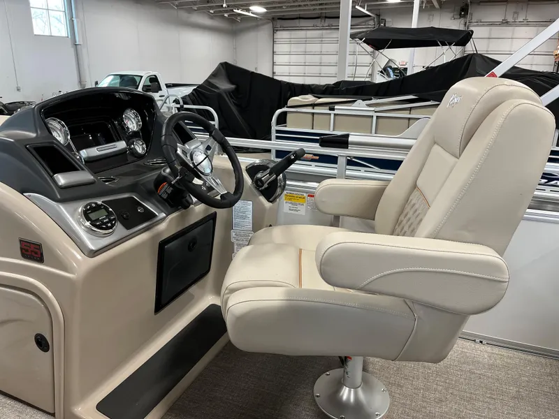 Slide: The Image of 2023 Ranger Reata 223C boat interior with captain's chair and control console. - 8