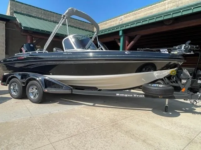 The Image of 2023 Ranger 1850MS boat on a trailer, black and white exterior. - 0