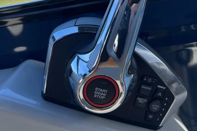 Slide: The Image of Close-up of 2023 Regency 230 LE3 Sport boat engine start-stop button. - 13