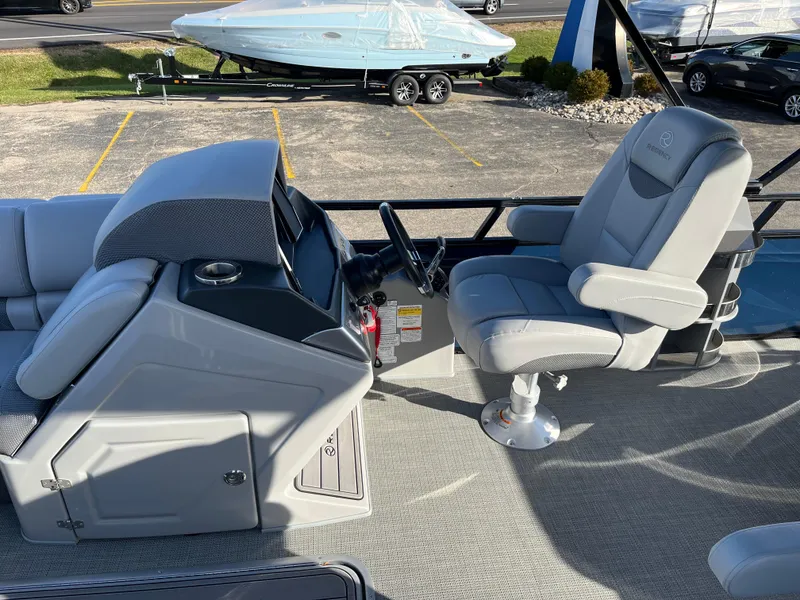 Slide: The Image of 2023 Regency 230 LE3 Sport boat interior with captain's chair and control console. - 3