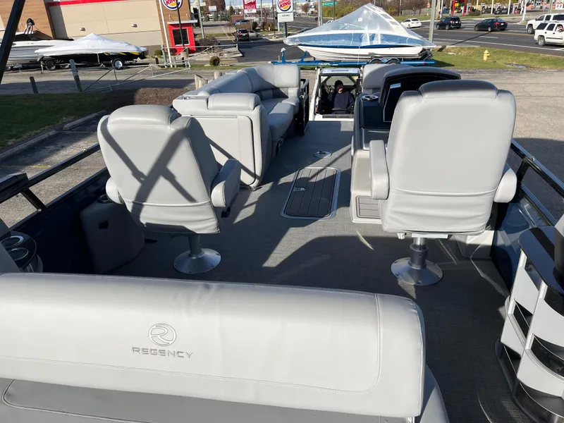 Slide: The Image of 2023 Regency 230 LE3 Sport pontoon boat with luxurious seating and modern design. - 7