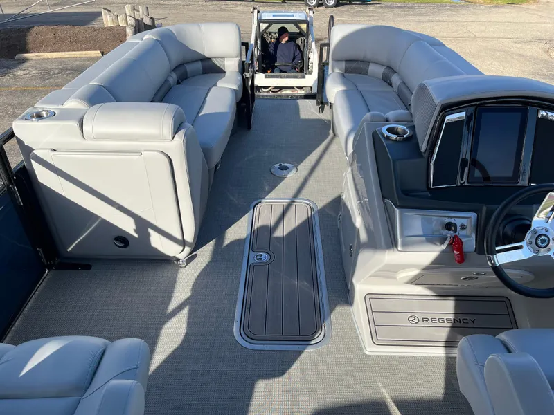 Slide: The Image of 2023 Regency 230 LE3 Sport pontoon boat interior with plush seating and modern helm. - 8