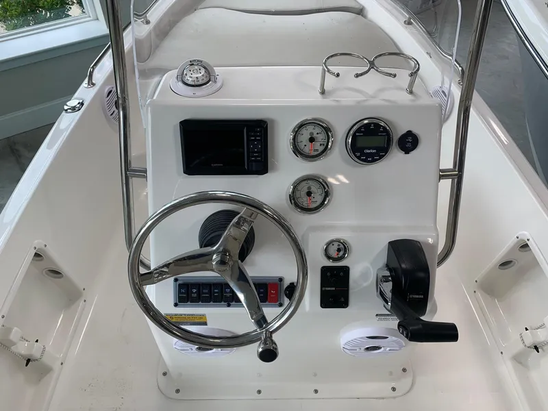 Slide: The Image of 2024 Key West 1720 Sportsman boat console with steering wheel, gauges, and controls. - 9