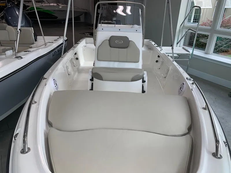 Slide: The Image of 2024 Key West 1720 Sportsman boat interior with cushioned seating and console. - 2