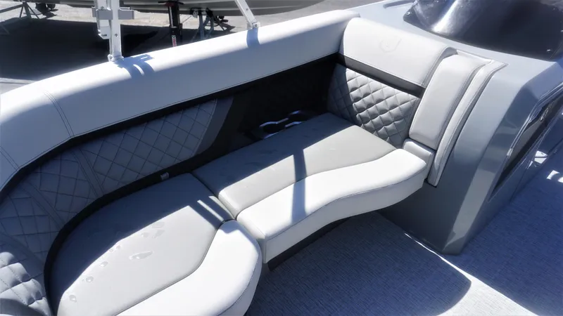 Slide: The Image of 2023 AquaPatio 235 ULC boat interior with grey quilted seating and cup holders. - 11