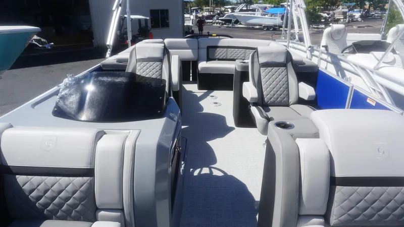 Slide: The Image of 2023 AquaPatio 235 ULC pontoon boat interior with luxurious seating and modern design. - 12