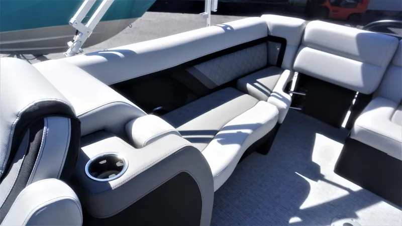 Slide: The Image of 2023 AquaPatio 235 ULC boat interior with luxurious seating and cup holder. - 14