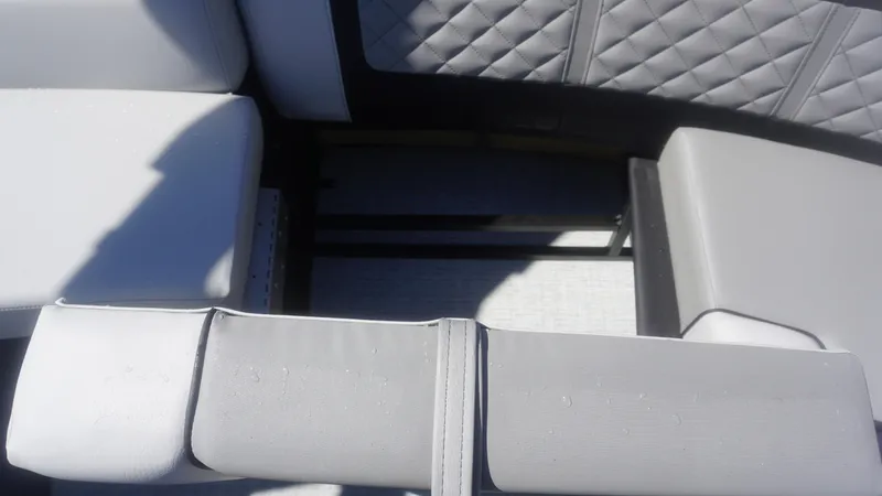 Slide: The Image of Close-up of 2023 AquaPatio 235 ULC boat's grey cushioned seating. - 19
