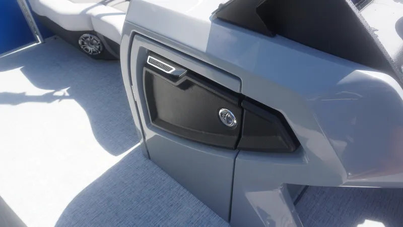 Slide: The Image of Close-up of the 2023 AquaPatio 235 ULC boat's sleek dashboard and storage compartment. - 22