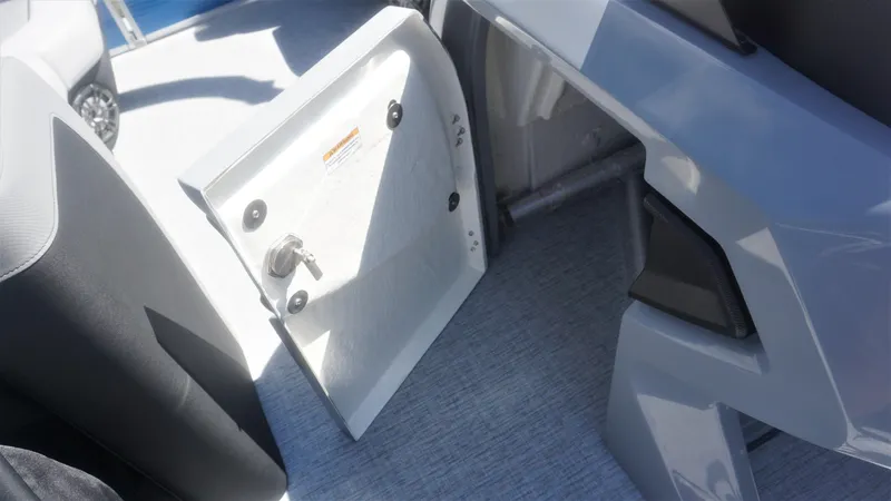 Slide: The Image of Open storage compartment on 2023 AquaPatio 235 ULC boat. - 23