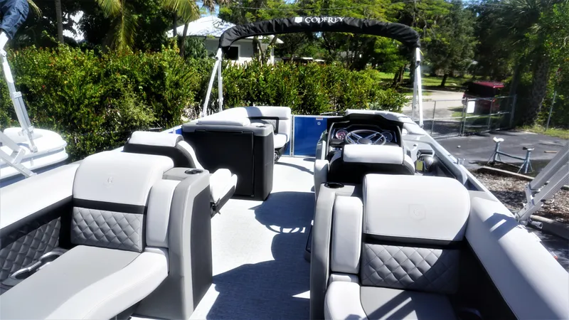 Slide: The Image of 2023 AquaPatio 235 ULC pontoon boat interior with luxurious seating and modern dashboard. - 24