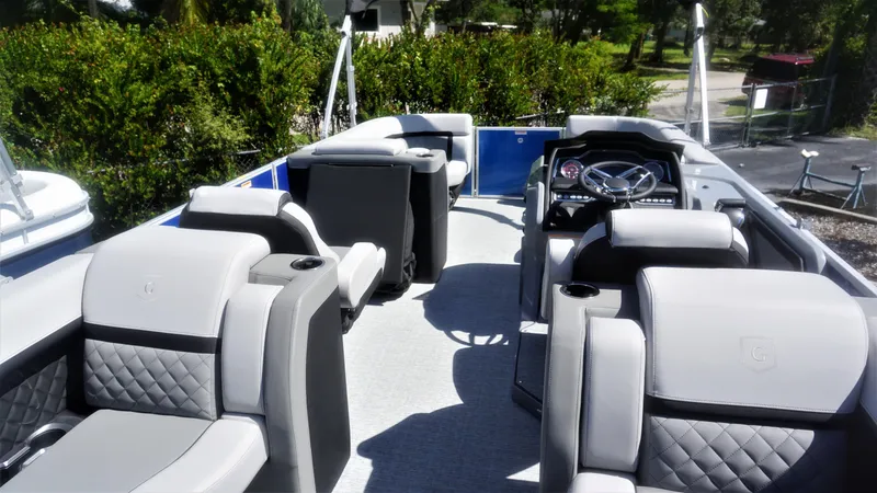 Slide: The Image of 2023 AquaPatio 235 ULC boat interior with luxurious seating and modern dashboard. - 3