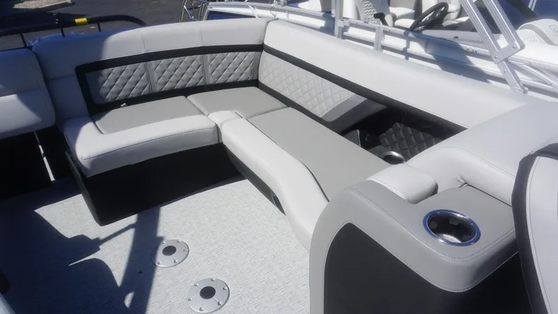 Slide: The Image of 2023 AquaPatio 235 ULC boat interior with luxurious seating and cup holders. - 4