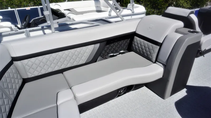 Slide: The Image of 2023 AquaPatio 235 ULC boat interior with luxurious gray seating and diamond stitching. - 5