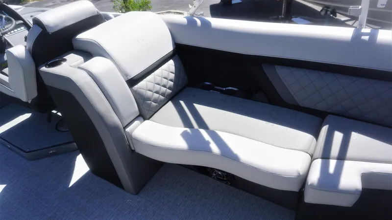 Slide: The Image of 2023 AquaPatio 235 ULC boat interior with luxurious seating and cup holder. - 6