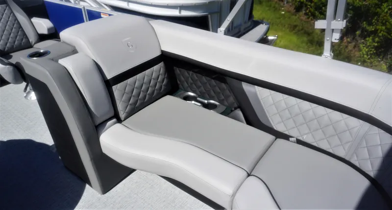 Slide: The Image of 2023 AquaPatio 235 ULC boat interior with luxurious gray seating and cup holders. - 7