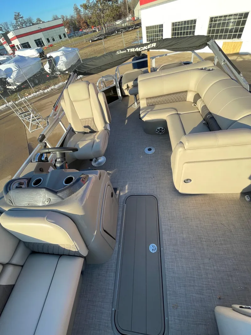 Slide: The Image of 2023 Sun Tracker SportFish 22 XP3 pontoon boat with spacious seating and modern design. - 3