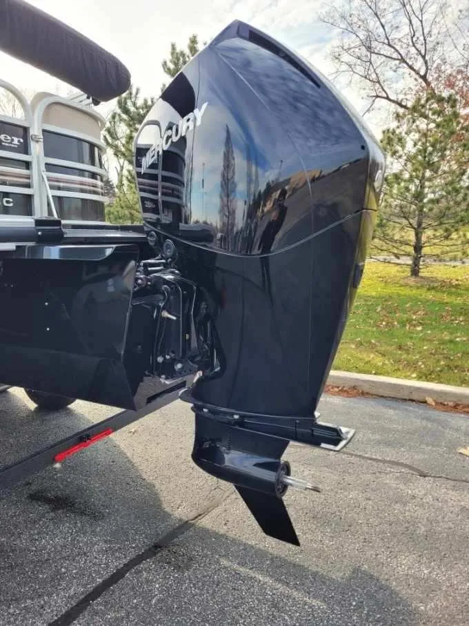 Slide: The Image of 2023 Ranger Reata 243C boat with a Mercury outboard motor. - 2