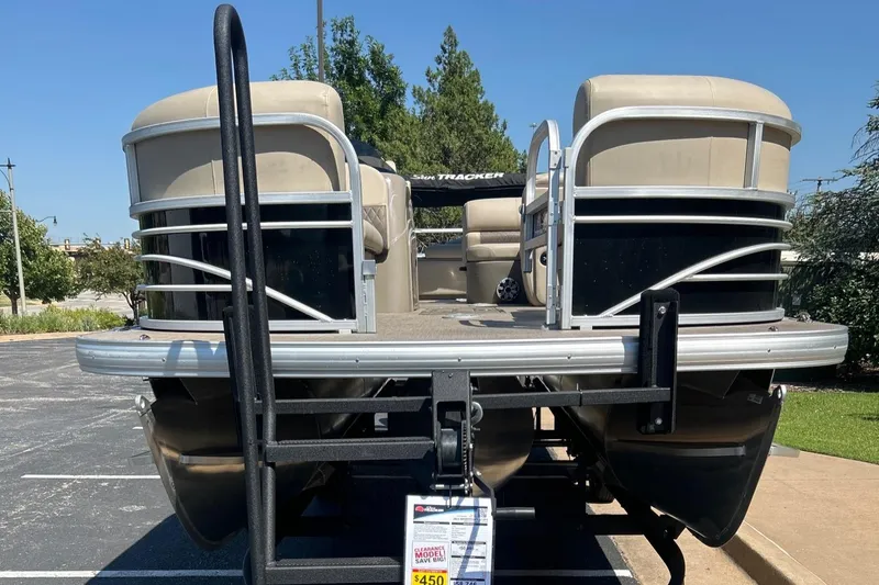 Slide: The Image of 2023 Sun Tracker SportFish 22 XP3 pontoon boat on trailer in parking lot. - 2