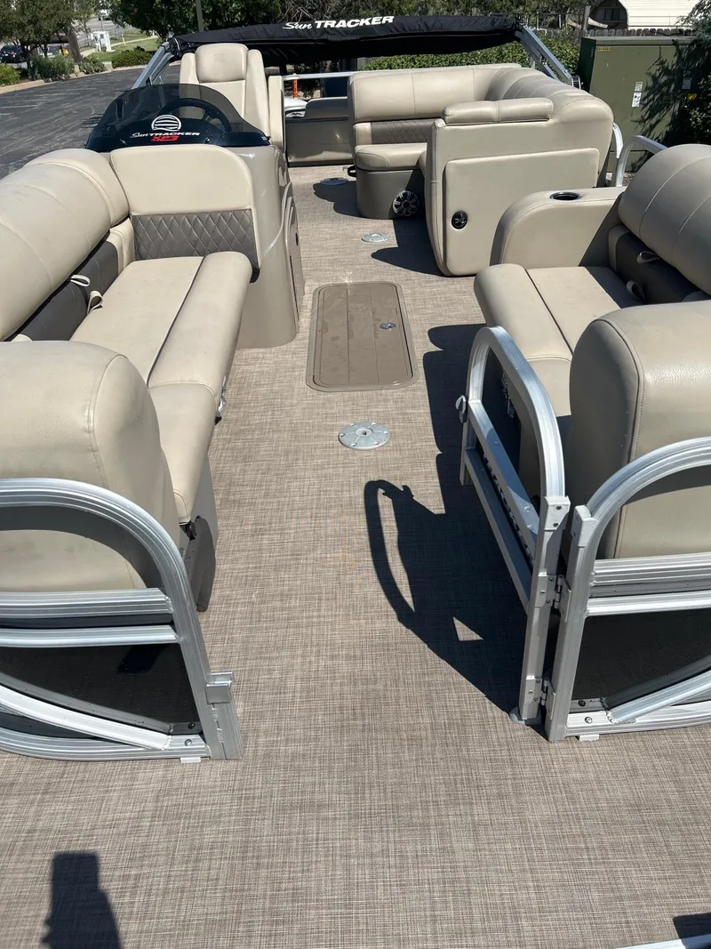 Slide: The Image of 2023 Sun Tracker SportFish 22 XP3 pontoon boat interior with beige seating. - 6