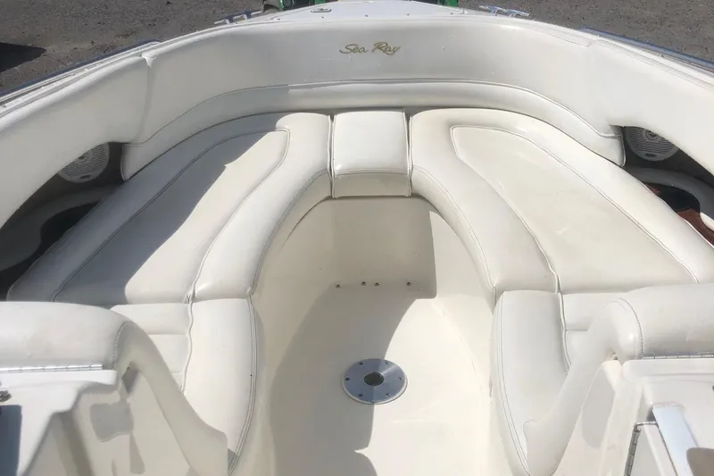 Slide: The Image of 2001 Sea Ray 280 boat interior with white cushioned seating. - 1