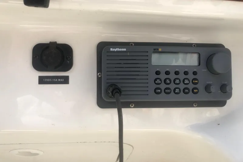 Slide: The Image of Raytheon marine radio on 2001 Sea Ray 280 boat dashboard. - 12