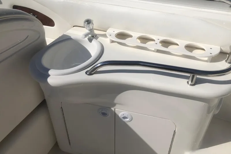 Slide: The Image of 2001 Sea Ray 280 boat interior with sink and cup holders. - 14