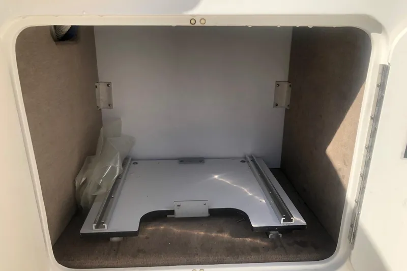 Slide: The Image of Storage compartment of 2001 Sea Ray 280 boat, featuring a white sliding platform. - 15