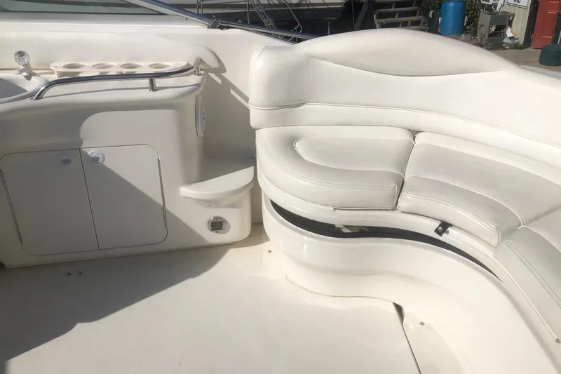 Slide: The Image of 2001 Sea Ray 280 boat interior with white seating and storage compartments. - 18