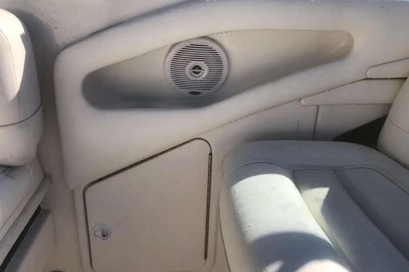 Slide: The Image of Interior of a 2001 Sea Ray 280 boat, featuring seating and speaker. - 22