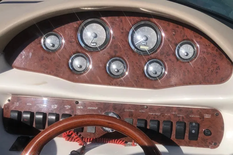Slide: The Image of Dashboard of a 2001 Sea Ray 280 boat with gauges and controls. - 3