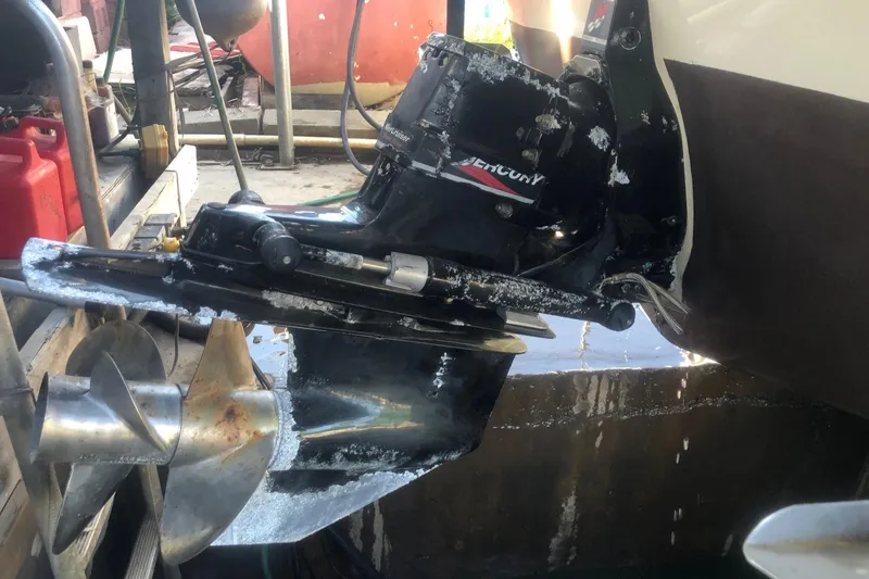 Slide: The Image of Close-up of a 2001 Sea Ray 280 boat's Mercury outdrive in water. - 4
