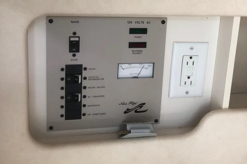 Slide: The Image of Control panel of a 2001 Sea Ray 280 boat with electrical switches and outlet. - 6