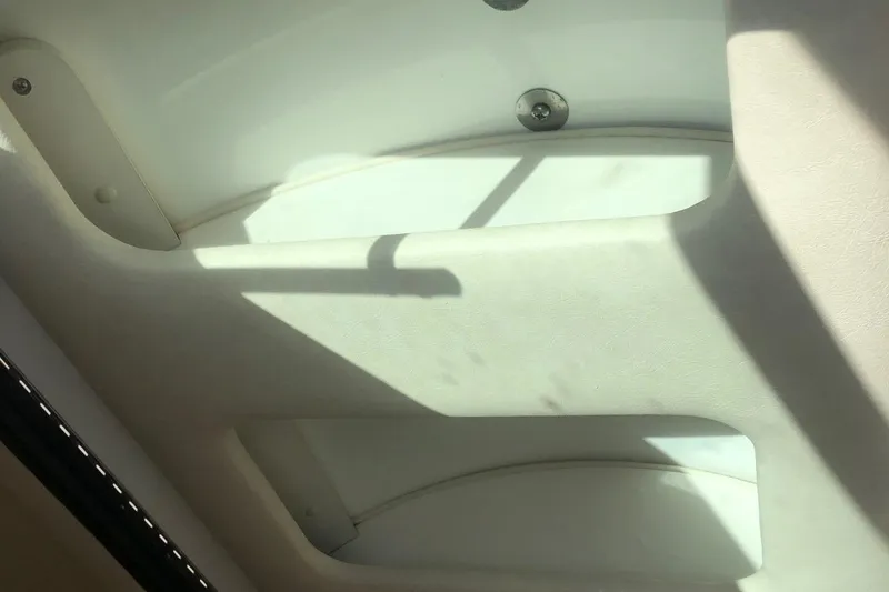 Slide: The Image of Interior view of 2001 Sea Ray 280 boat, featuring white seating area. - 8